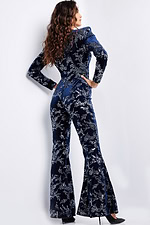 Back view of model wearing Jovani 23708 navy jumpsuit with intricate details.