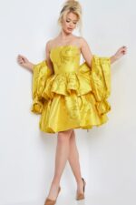 Model wearing Jovani 23743 yellow cocktail dress from the front, showing detached puff sleeves and ruffle details.