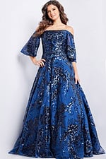Model wearing Jovani 23765 navy dress, front view showing off-the-shoulder neckline and sequin details.