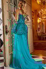 Model wearing Jovani 23777 blue gown with sequins, demonstrating the back view with a flowing train.