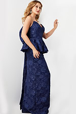 Model in Jovani 23849 navy gown from side view with peplum detail.