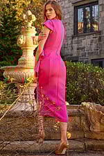 Model wearing Jovani 23856 fuchsia dress back view highlighting silhouette.