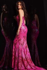 Model wearing Jovani 23876 in pink, back view showcasing mermaid silhouette.