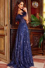 Model in Jovani 23884 navy gown with feathered neckline showing back view with sequined details.