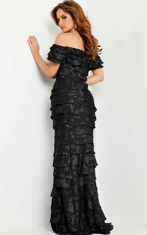 Model in Jovani 23890 showcasing elegant off-the-shoulder black dress, front view.