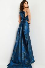 Rear view of model in Jovani 23898 navy dress highlighting the bow and train.
