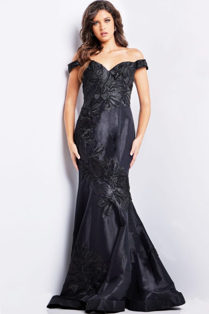 Model wearing Jovani 23928 black dress with off-the-shoulder neckline, front view.