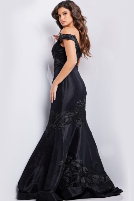 Model wearing Jovani 23928 black dress, back view showcasing mermaid silhouette.