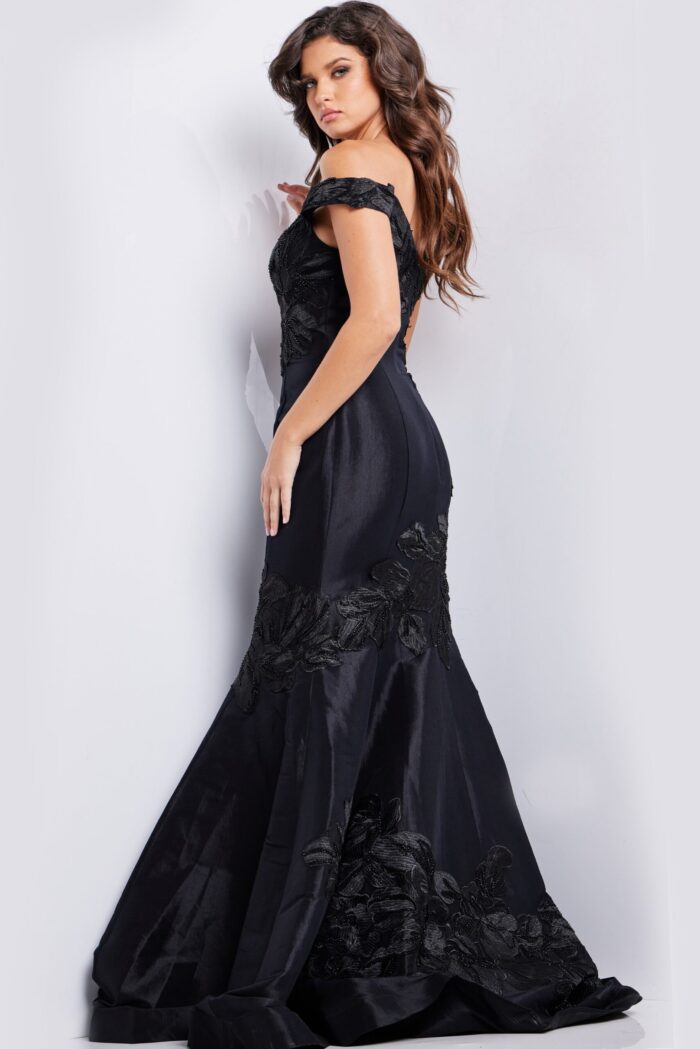Model wearing Jovani 23928 black dress, back view showcasing mermaid silhouette.