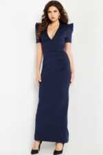Model wearing Jovani 24021 navy dress with deep V-neckline, full-length view.