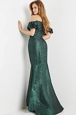 Model wearing Jovani 24044 green dress with mermaid silhouette, viewed from the back.