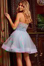 Model wearing Jovani K24050, back view showing strapless blue dress.