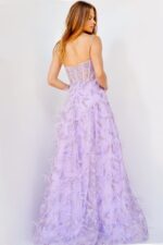 Model wearing Jovani 24078 lilac dress showcasing the back view with detailed feather embellishments.