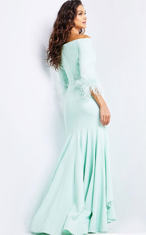 Model wearing Jovani 24195 green gown showcasing back detailing