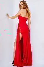 Model wearing Jovani 24263 red gown with sweetheart neckline and high slit, back view.
