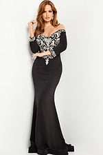 Model wearing Jovani 24328 black mermaid gown with silver embellishments.