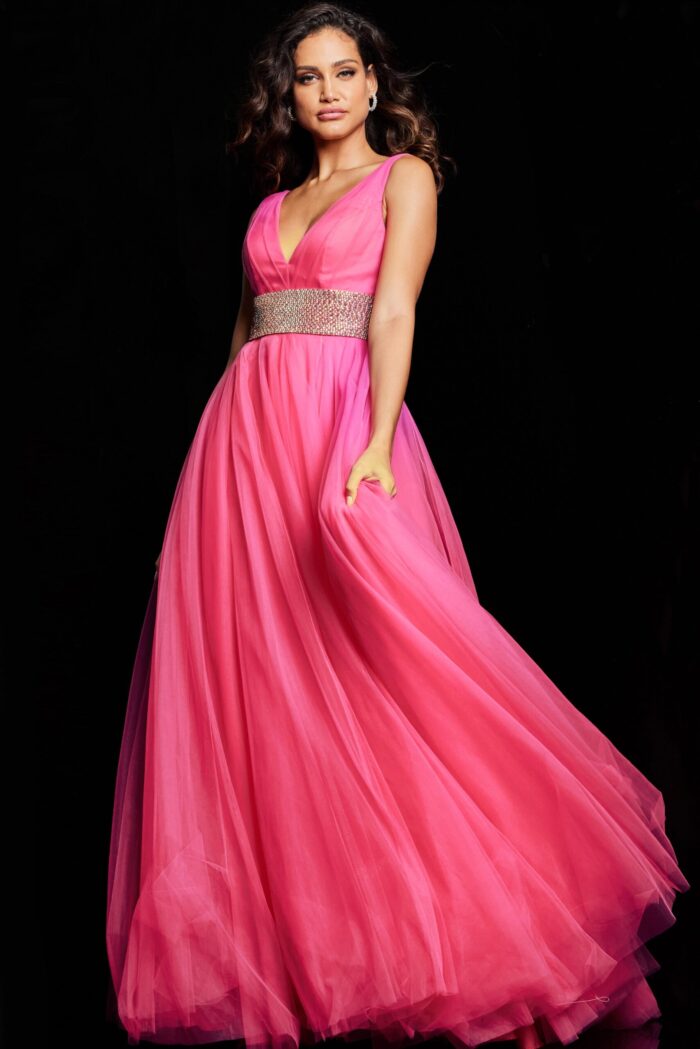Model wearing Jovani 24564 hot pink gown with flowing skirt, frontal view.