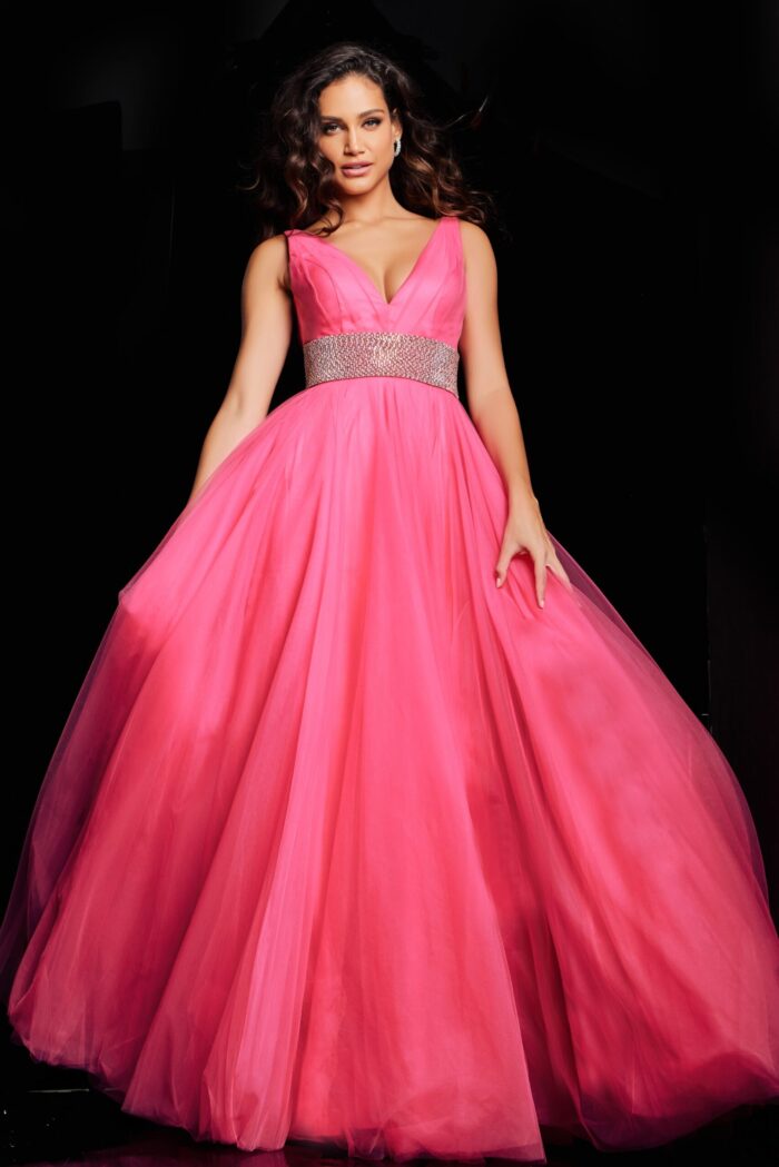 Model wearing Jovani 24564 hot pink gown, showcasing flowing movement and deep V-neckline.