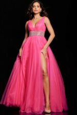 Model wearing Jovani 24564 hot pink gown showcasing embellished waistband, front angle view.