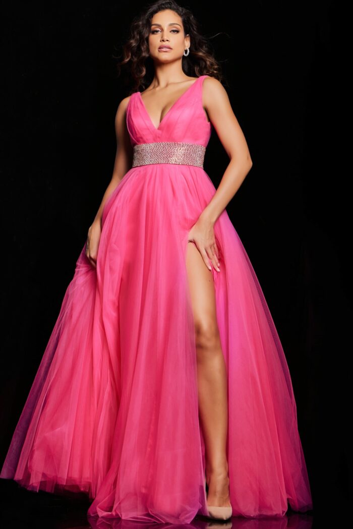 Model wearing Jovani 24564 hot pink gown showcasing embellished waistband, front angle view.