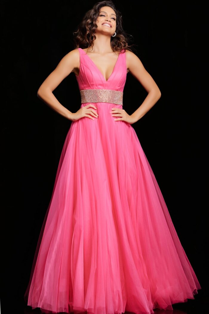 Model wearing Jovani 24564 hot pink gown, highlighting floor-length skirt, front view.