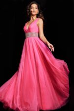 Model wearing Jovani 24564 hot pink gown, floating tulle fabric and embellished waist.