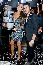 Model wearing Jovani 73060 navy cocktail dress with detailed beadwork and accompanying figure.