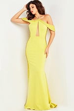 Model wearing Jovani 24611 yellow gown with a keyhole cutout and embellishments.