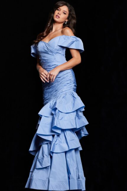 Model wearing Jovani 24646 blue mermaid dress with sweetheart neckline and ruffled skirt.