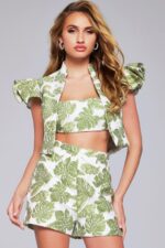 Model wearing Jovani 24649 two-piece set, front view with leaf print and ruffled sleeves.