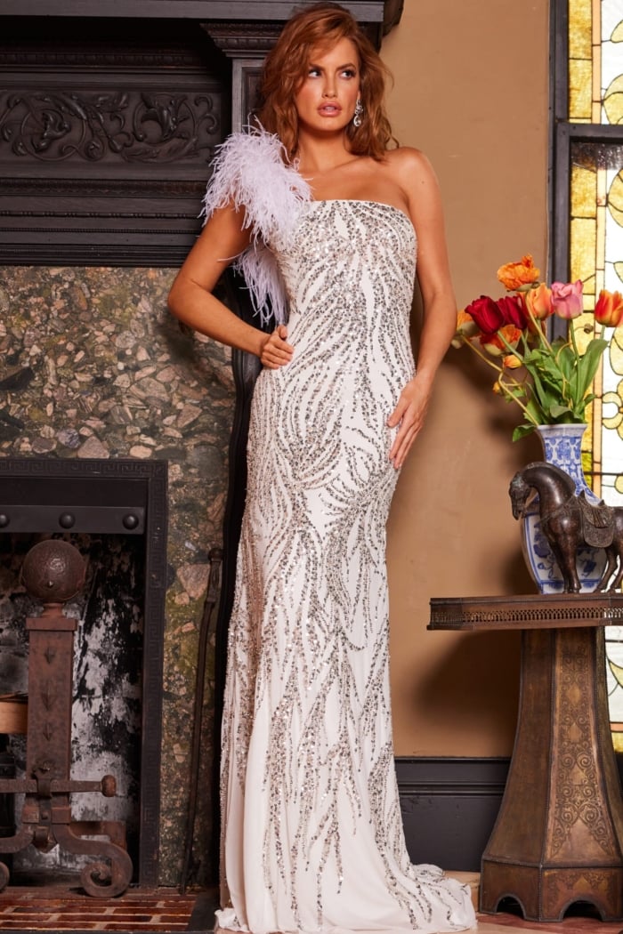 Model wears Jovani 25690 white gown with elaborate sequined detail.