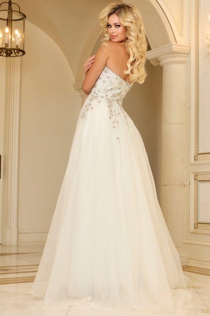 Model wearing Jovani 25691 white evening gown, back view with embellishment detail.