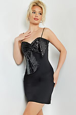Model in Jovani 25744 black dress, showcasing front with sequin embellishment.