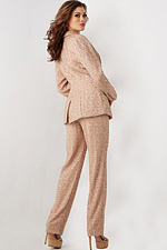 Model wearing Jovani 25773 beige sequin blazer and trousers ensemble, back view.