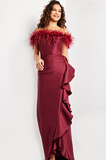 Model wearing Jovani 25786 burgundy gown with feather detailing and ruffles, side view.