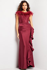 Model wearing Jovani 25786 burgundy gown with feather neckline and ruffle design, front view.