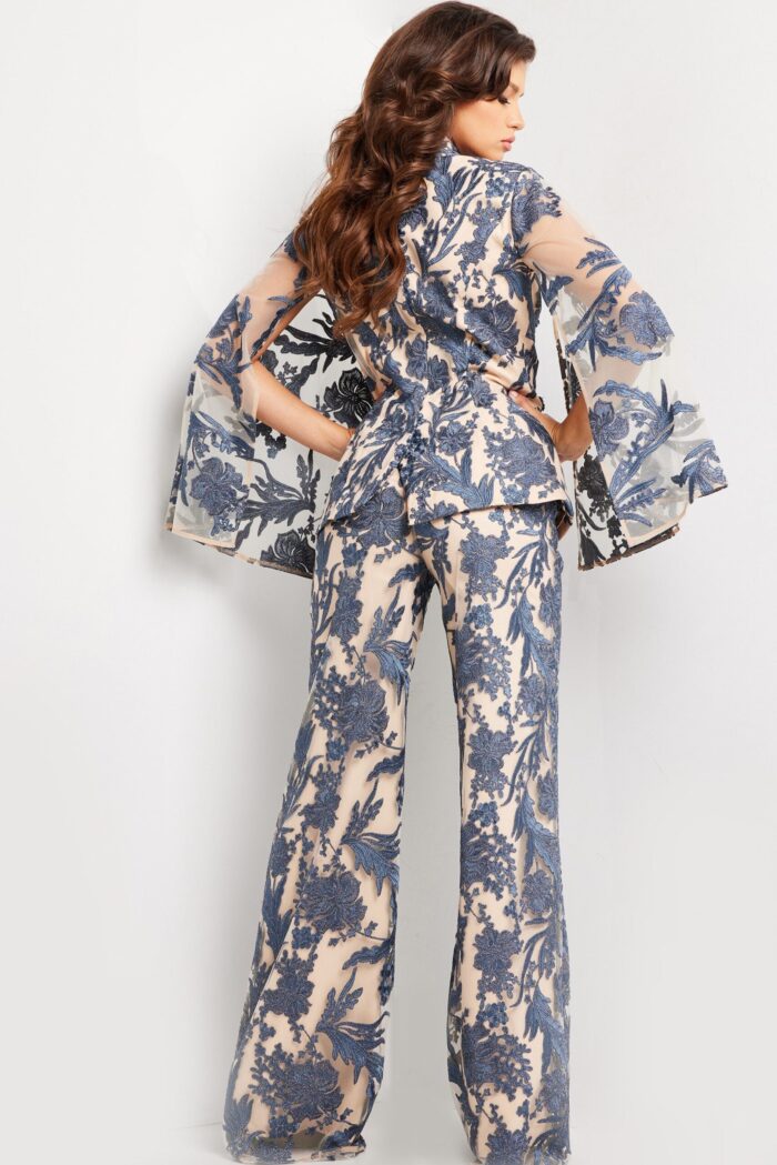 Model wearing 25805 navy dress with detailed lace embroidery, back view.