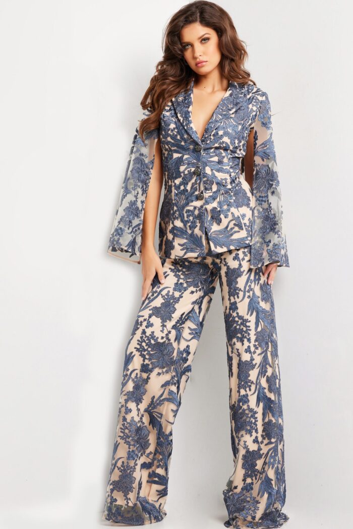 Model wearing 25805 navy dress with plunging V-neckline and sheer sleeves, front view.