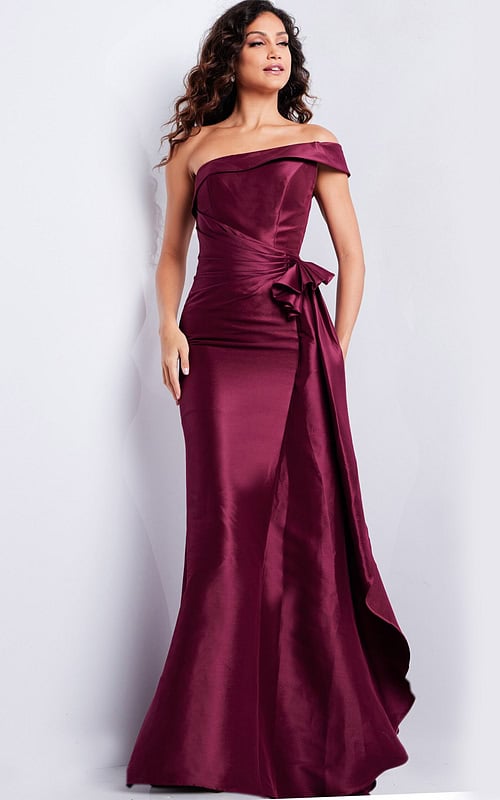 Model wearing Jovani 25831 burgundy off-shoulder dress with floor-length design.