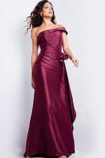 Model showcasing Jovani 25831 burgundy dress, featuring an elegant off-shoulder silhouette.