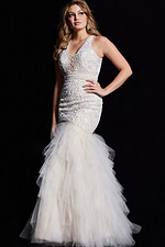 Model wearing Jovani 25854 ivory gown with deep V-neck and layered tulle mermaid skirt