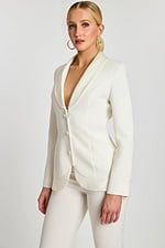 Close-up of off-white tailored blazer with deep neckline, satin trim, and covered buttons.