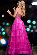 Model wearing Jovani 26011 pink gown with beaded bodice and layered skirt, back view.