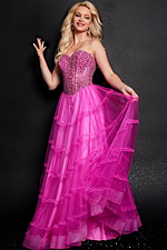 Model wearing Jovani 26011 pink gown with beaded bodice and layered skirt, front view.