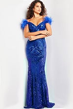 Model wearing Jovani 26041 royal blue off-the-shoulder gown with feathers.