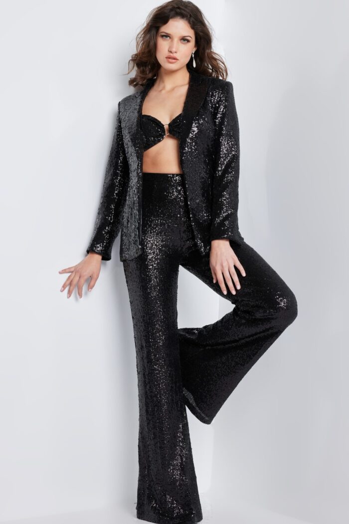 Model wearing Jovani 26042 black sequin jacket and pants set, front view.