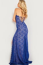 Model wearing Jovani 26051 royal blue lace gown with lace-up back design.