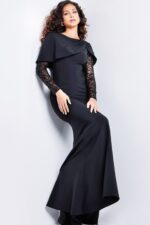 Model showcasing Jovani 26062 black gown with asymmetrical neckline and lace sleeve details.