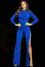 model wearing Jovani 26080 royal blue gown with long sleeves and a high slit