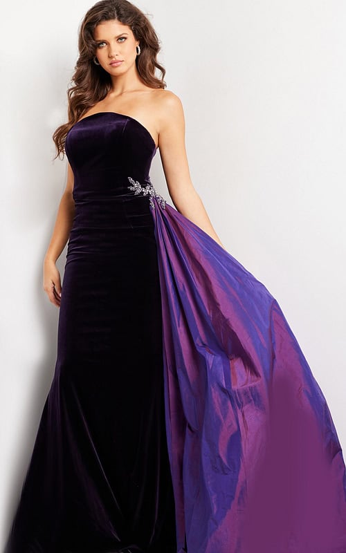 model wearing 26116 purple velvet gown with strapless neckline and dramatic side overlay